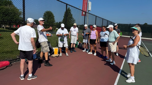 Peter receives a "Silver Sneaker" award recognizing his tireless retreival of stray balls while standing down from active play